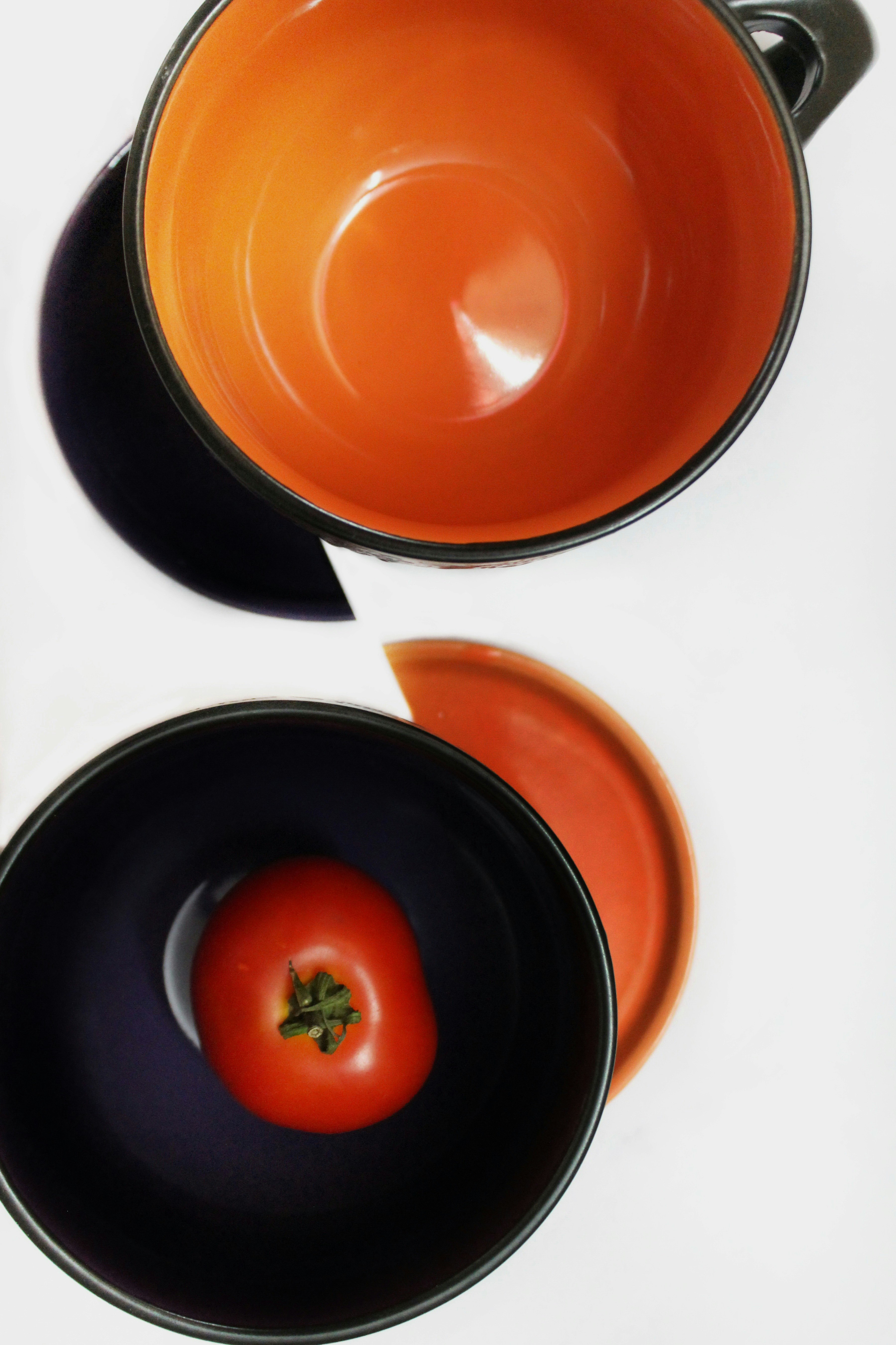 orange round ceramic bowl on white table